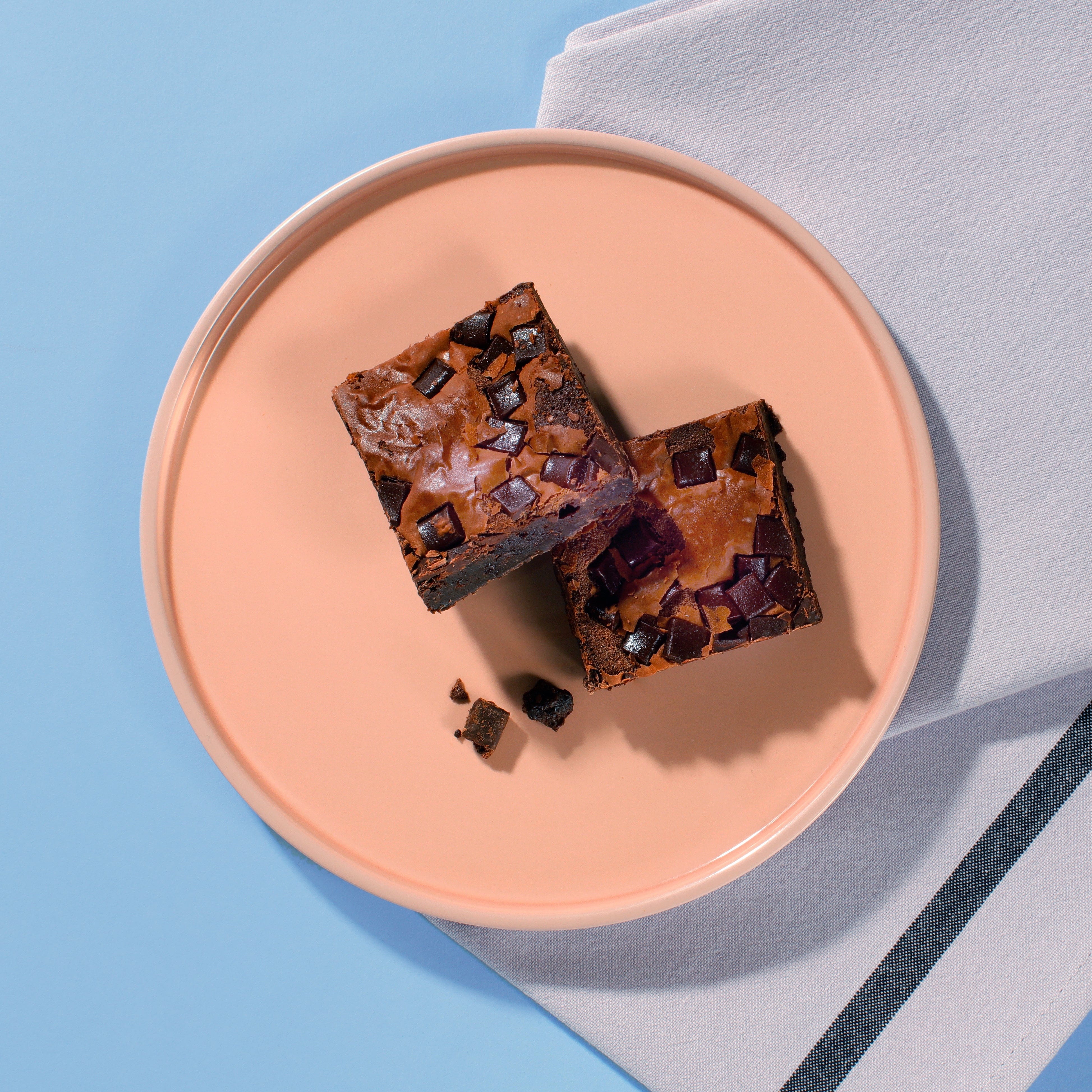 Close-up of Choc Chunk Brownie squares showing rich dark chocolate chunks.