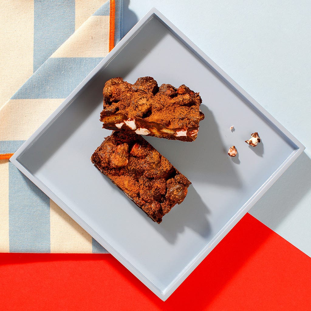 An overhead view of our Rocky Road traybake slices on a square grey plate.