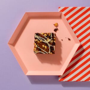 An overhead view of one of our Salted Caramel And Comb Brownies on an hexagonal plate.