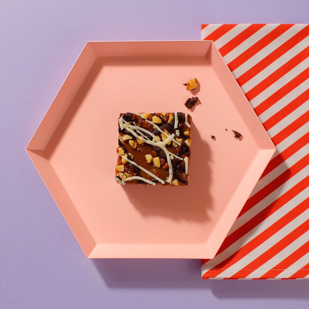An overhead view of one of our Salted Caramel And Comb Brownies on an hexagonal plate.