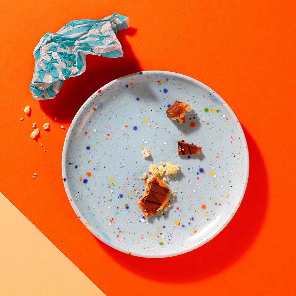 Empty plate with crumbs from The Millionaire shortbread traybake – buttery shortcake and caramel layers.