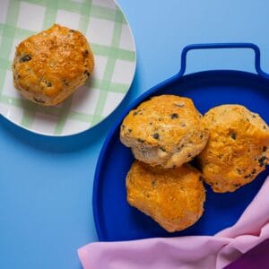Black Olive Scones arranged on a blue tray, ready for coffee shop service.