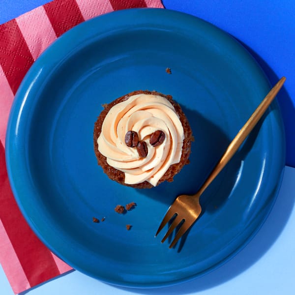 Overhead view of a Little Latte cupcake from CakeClub - a creamy frosting on top of a delicious coffee-flavoured treat.