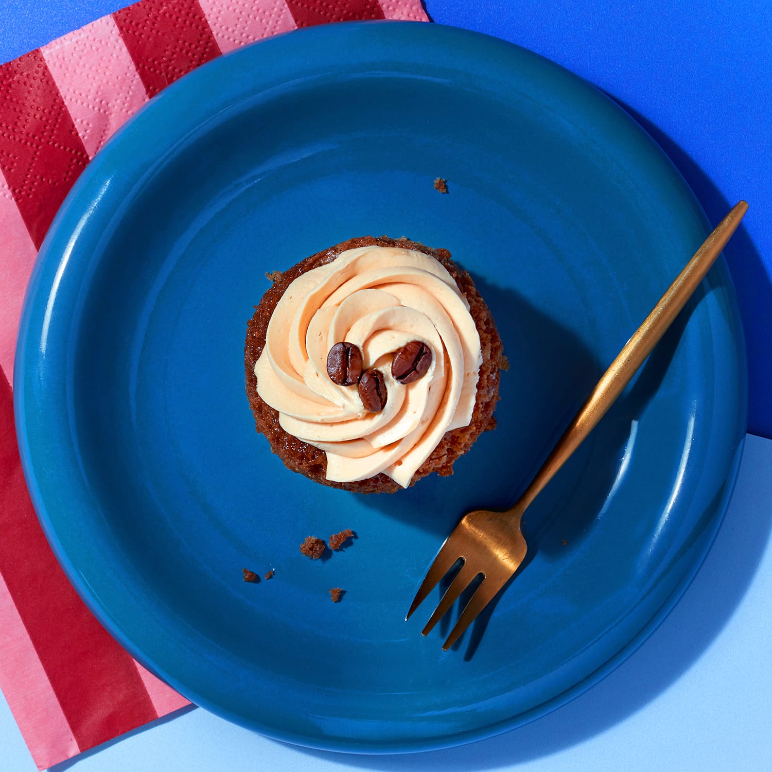 Overhead view of a Little Latte cupcake from CakeClub - a creamy frosting on top of a delicious coffee-flavoured treat.